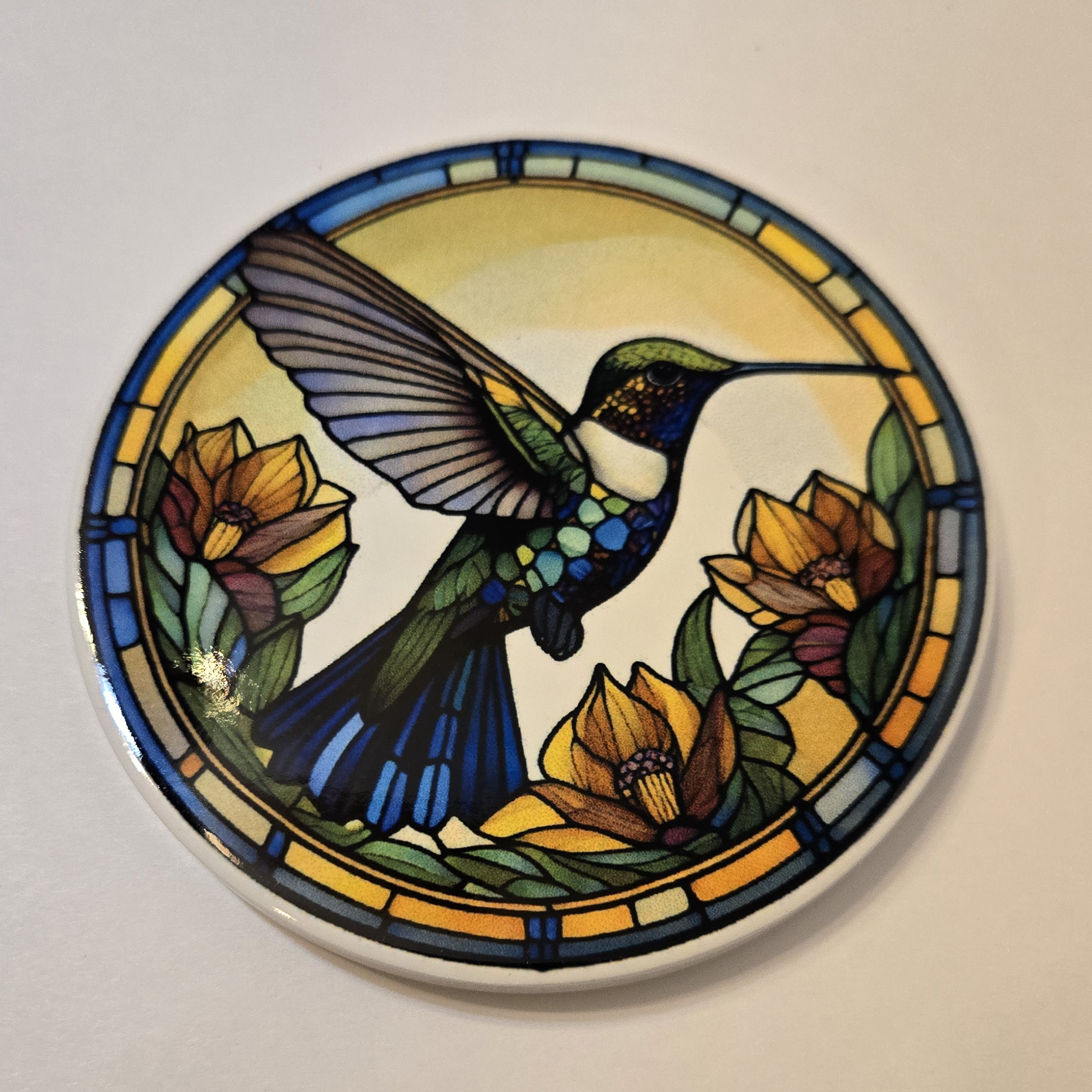Round ceramic coaster with a stained glass hummingbird desing