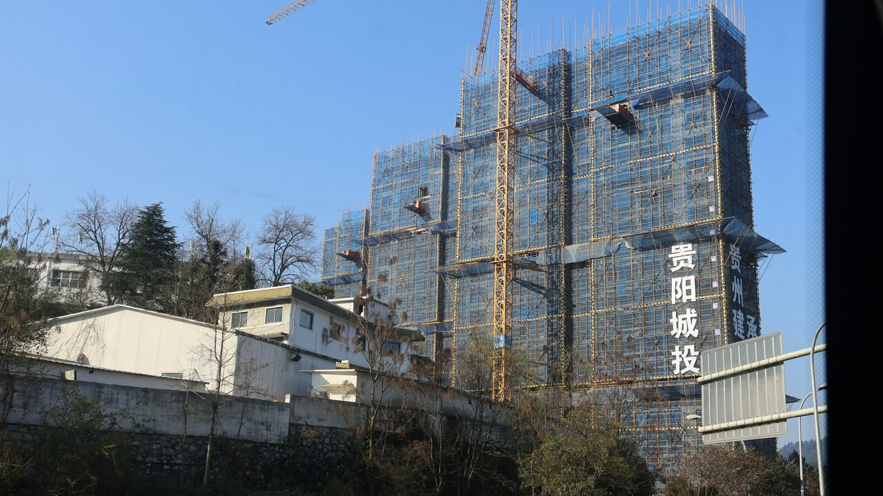 Building under construction with cranes and scaffolding