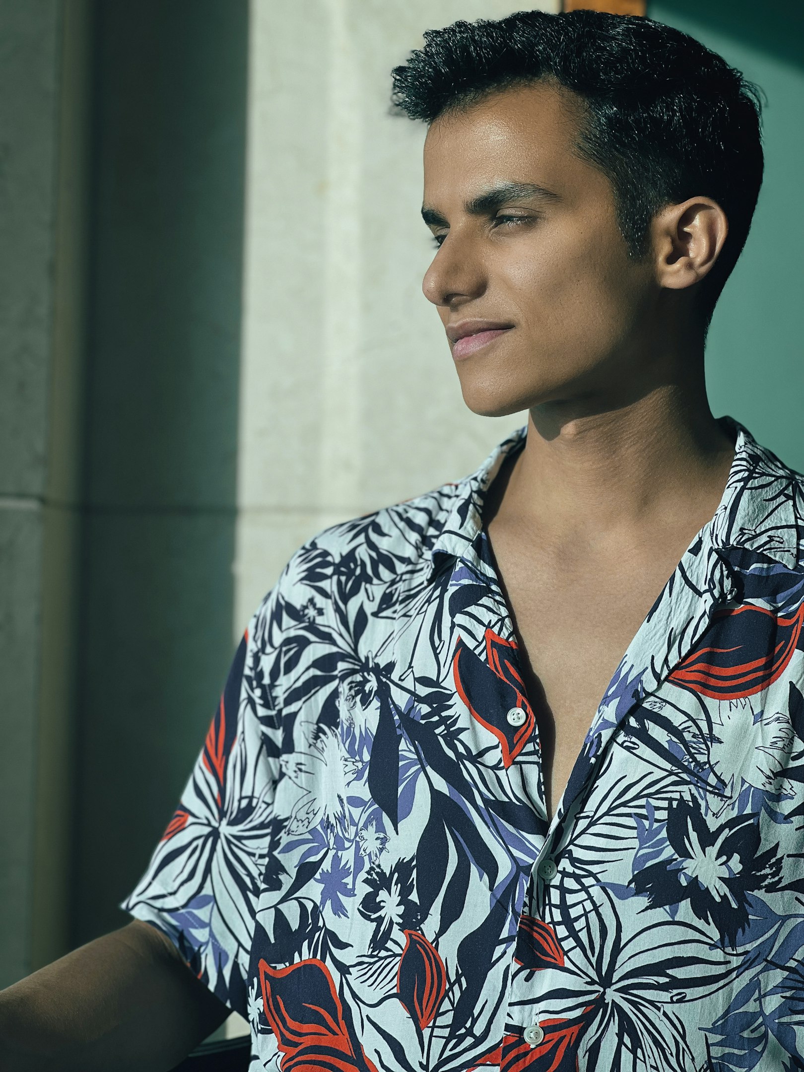a man in a hawaiian shirt looking off into the distance