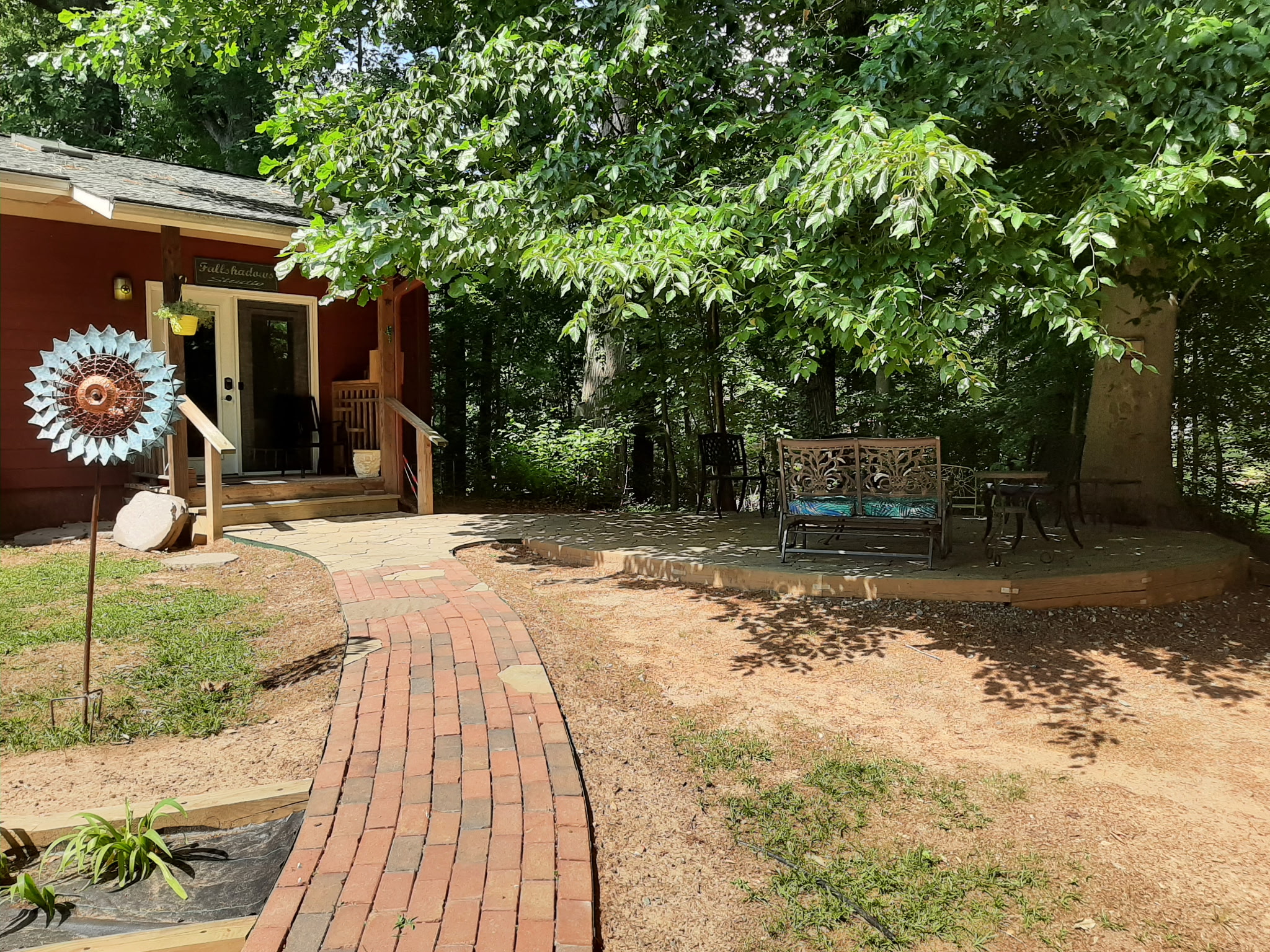 Brick walkway to studio doors and patio