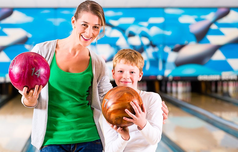 Boy And Woman Bowling