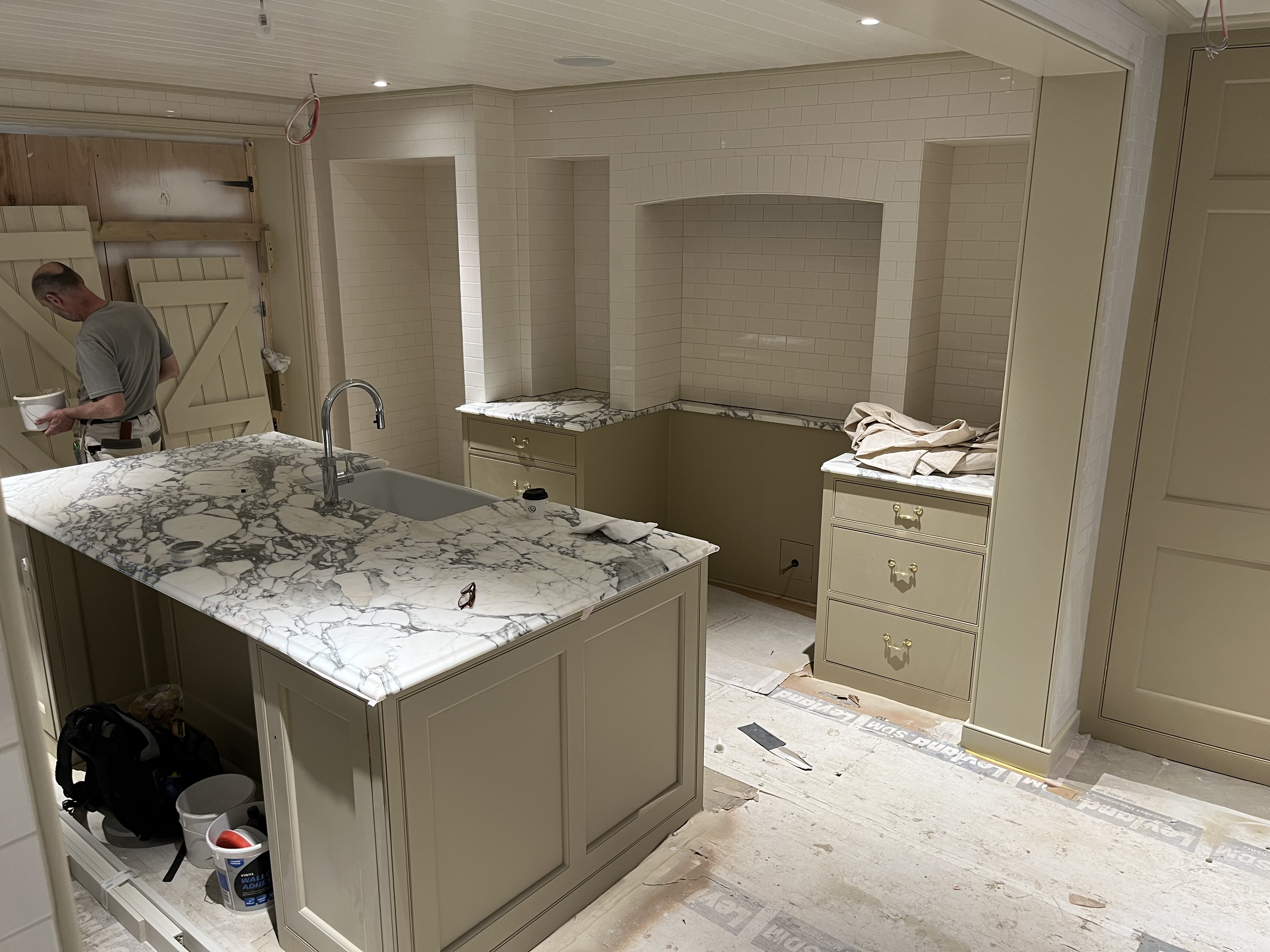 a room with a table chairs and a lamp