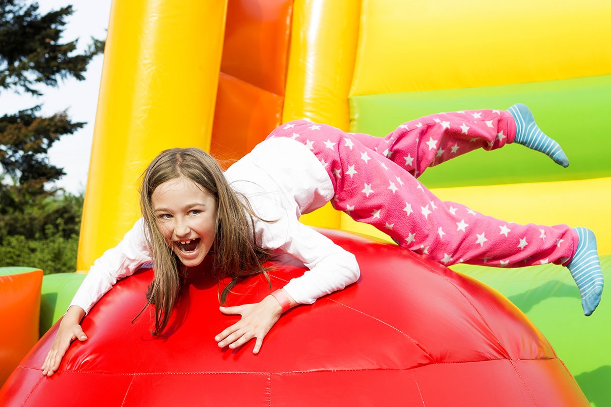 Girl Having Lots Of Fun On A Inflate Castle While Jumping