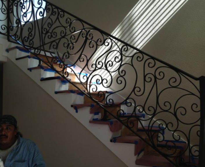 Wrought iron bannister on an interior stairway.