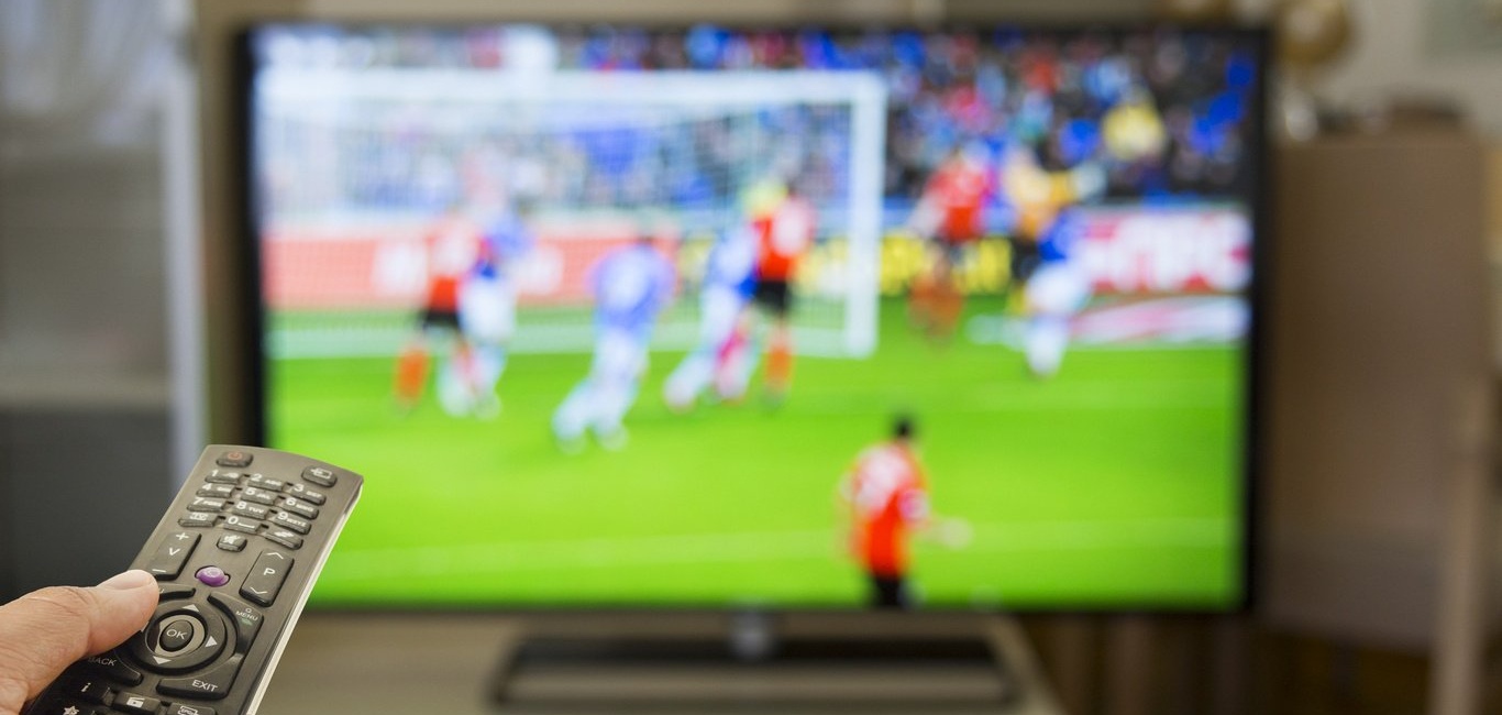 Assistindo futebol em casa na TV foto royalty-free