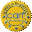 Yellow and blue CARF accreditation seal with 'Aspire to Excellence