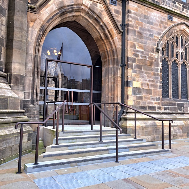 Bronze metal finishing AM.2 bright bronze finish on stainless steel handrails and aluminium window frames.  Rochdale Town Hall. Artistic Metals Ltd
