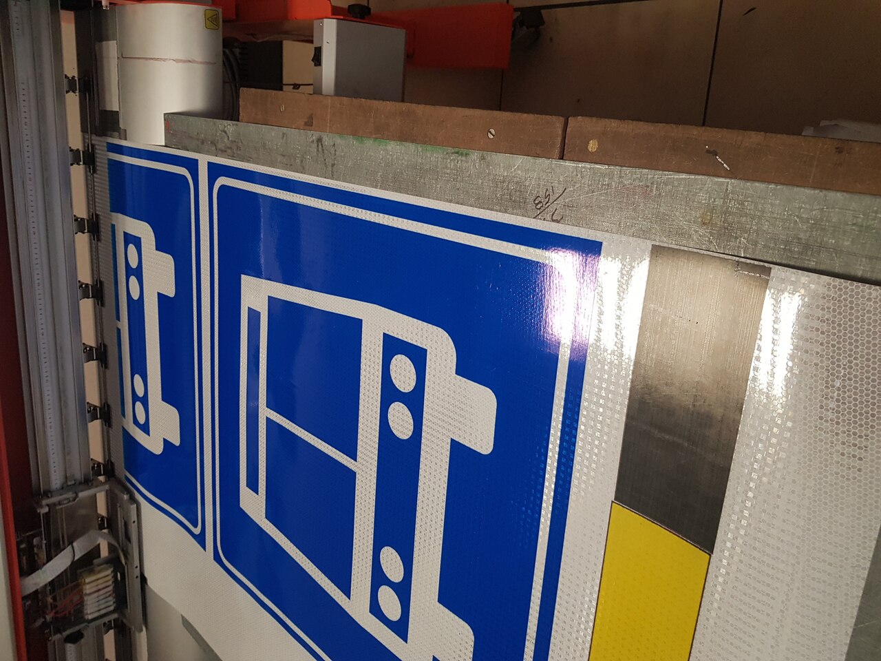 Calle urbana con múltiples señales de tráfico, incluyendo límites de velocidad y advertencias de cruce peatonal, rodeada de edificios modernos y arbolado.
