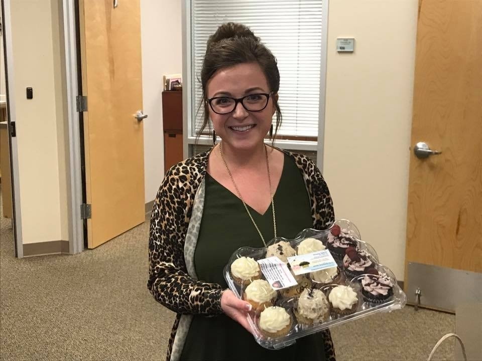 Woman With Assorted Cupcakes
