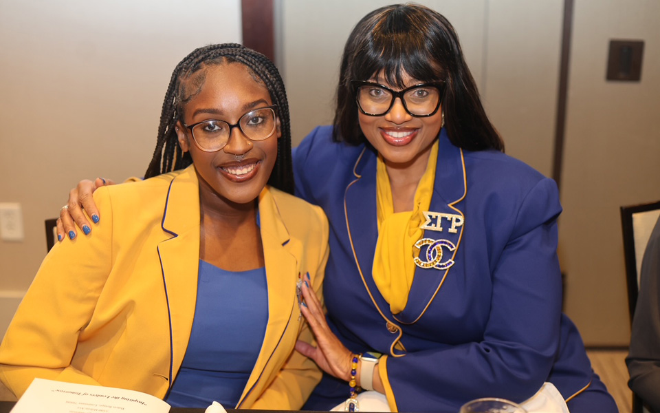Two people posing at an event