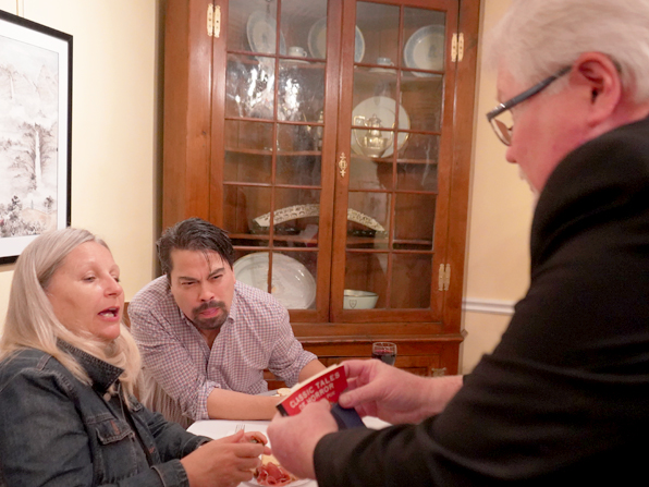 Chuck performing another table magic effect with the help of two spectators.