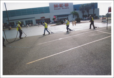 Men seal coating the pavement||||