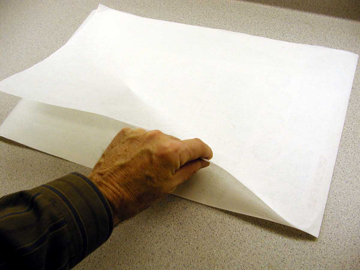 Now apply the tissue to the backing sheet. Smooth out any wrinkles that may develop. We typically use the heavier grade of tissue known as art tissue or shoe box tissue. This tissue has a denser white and produces good color. The nice very light grades of tissue also work quite well.