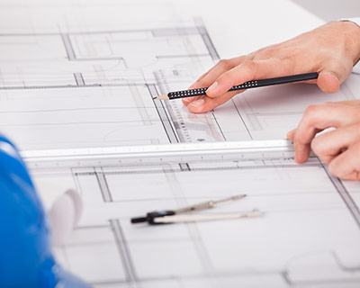 Architect Working On Blueprint Design
