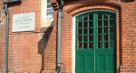 a room with a table chairs and a lamp