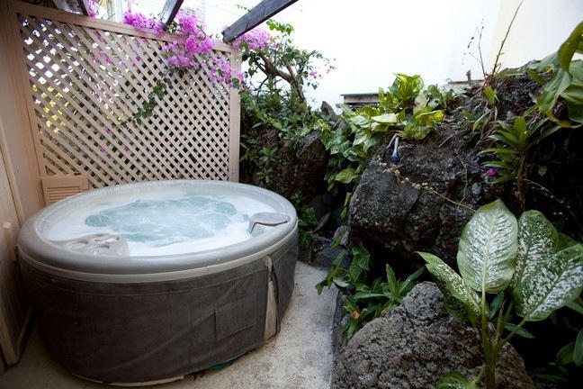 We can create a cozy nook with a tropical feel for a spa getaway in your backyard. 