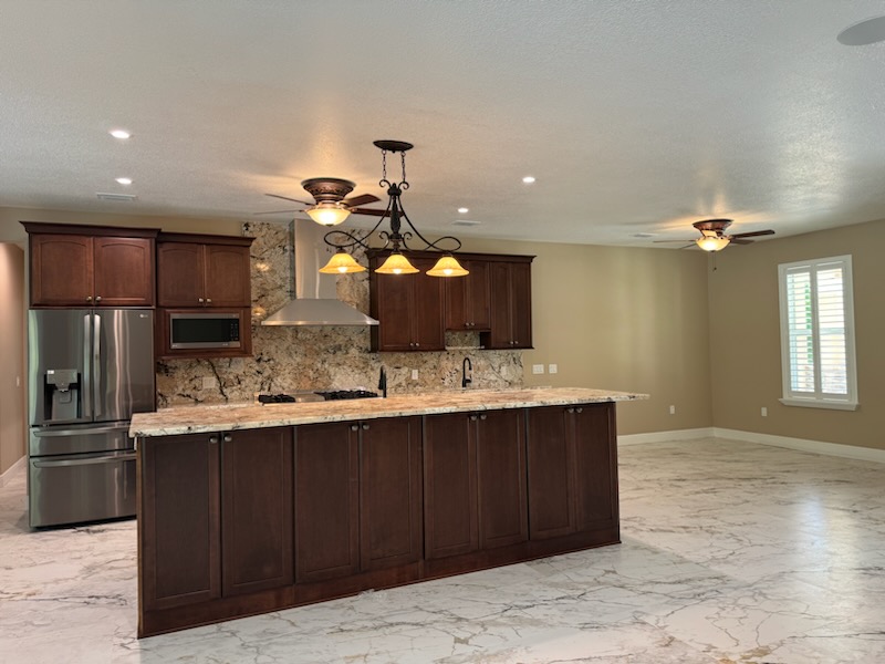 A large island featuring a high bar is a perfect spot for friends and family to gather.