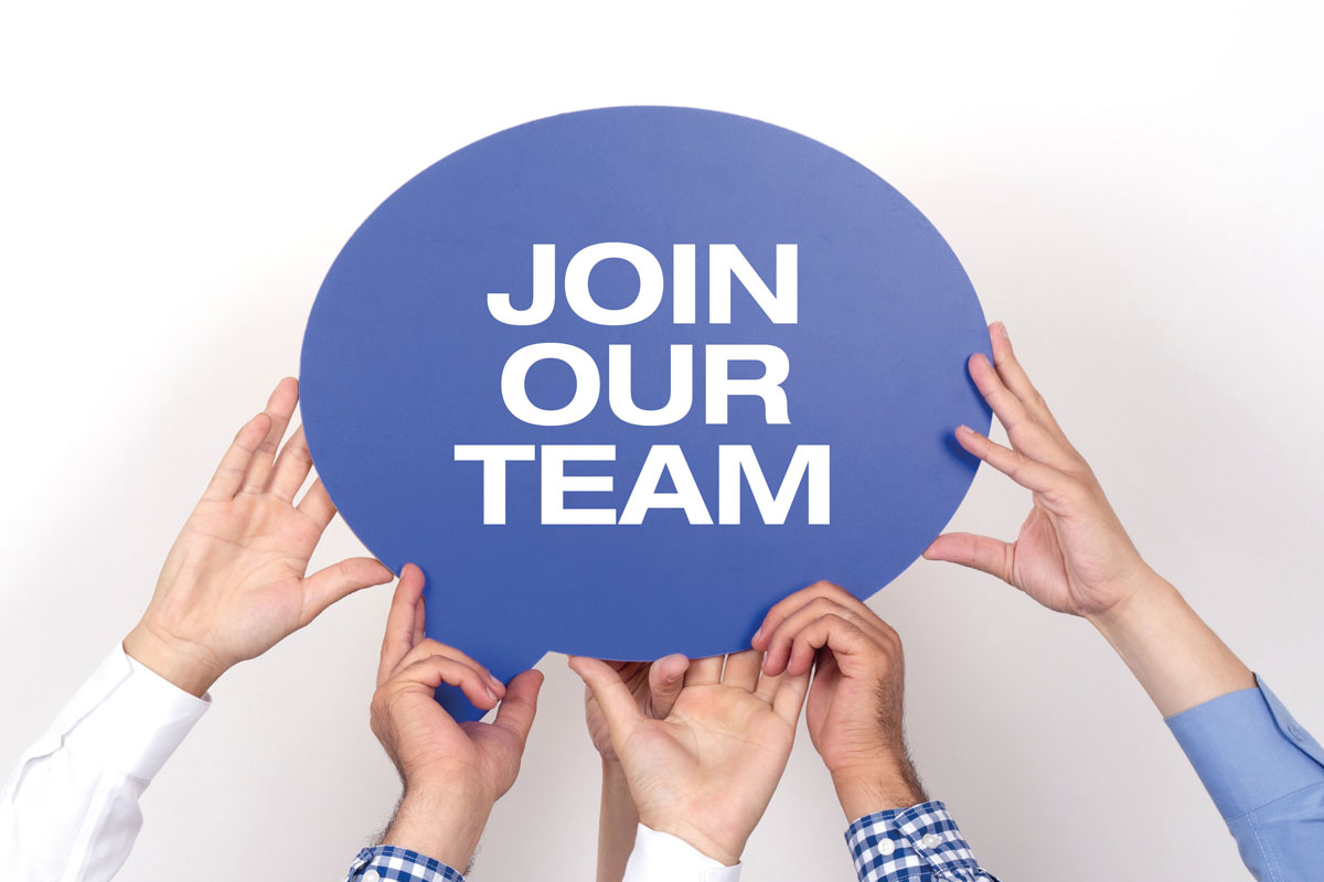 Group Of People Holding The JOIN OUR TEAM