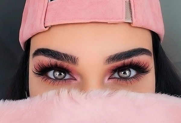 Professional makeup artist applying makeup for a young woman in a studio Professional makeup artist applying makeup for a young woman in a studio