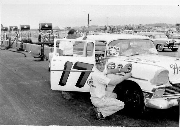 Ed Justice, Sr. putting on a decal on a early NASCAR car