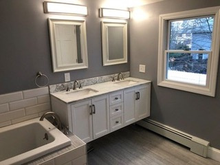 Installed a Anderson high performance double hung window, re-framed all perimeter walls, closed cell insulation, electrical, plumbing, heat element, stone tile floor, and wall hung double sink vanity.