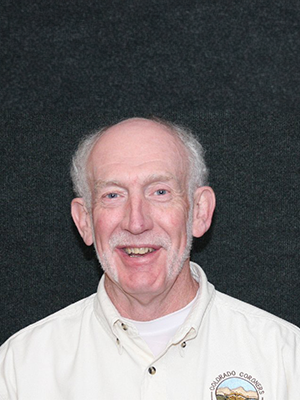 A smiling man in a white shirt