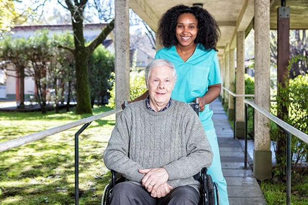 African Nurse Helping Man