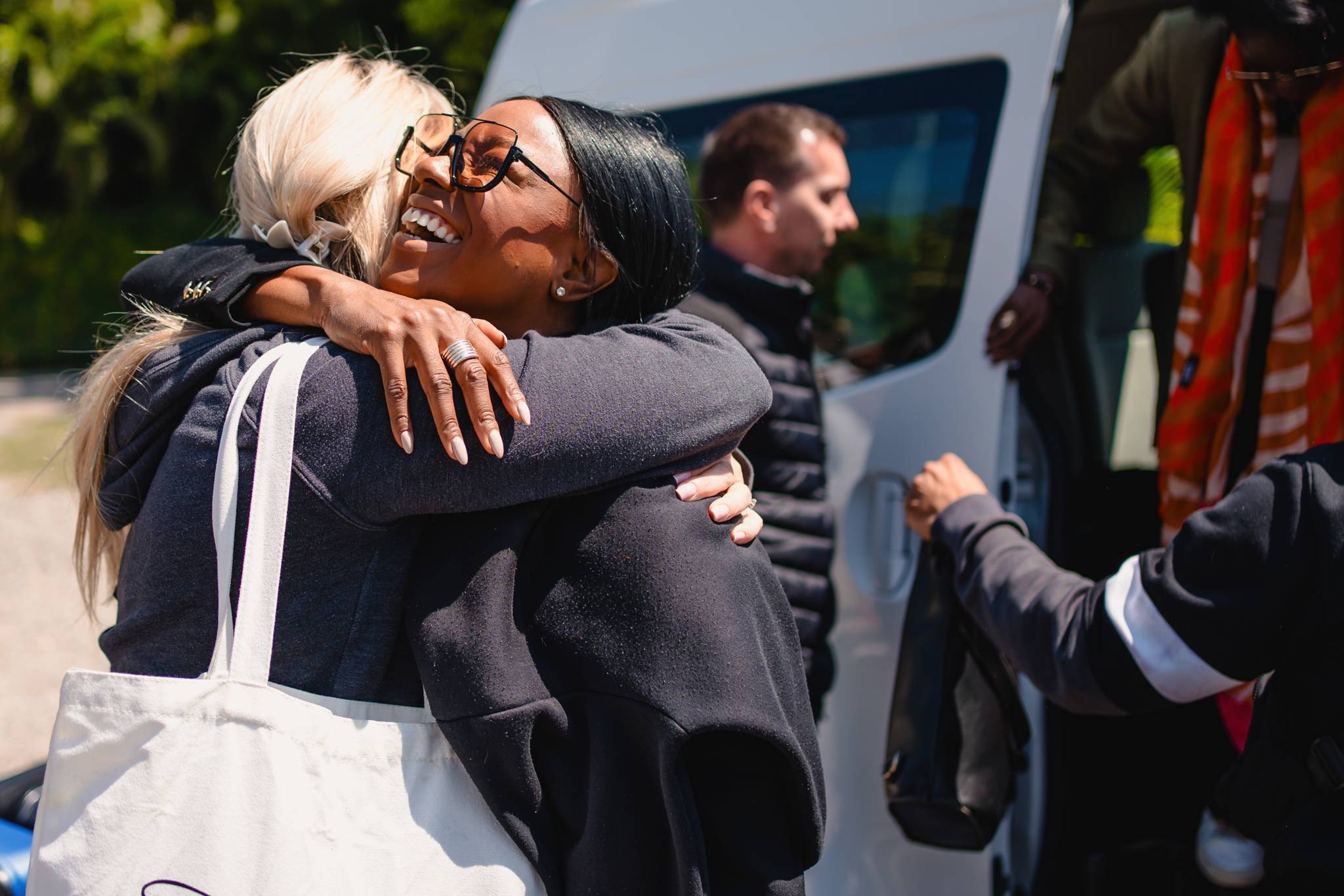 Friends sharing laughter before arriving at the wedding venue.