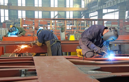 Steel Workers Welding, Grinding, Cutting in Metal Industry
