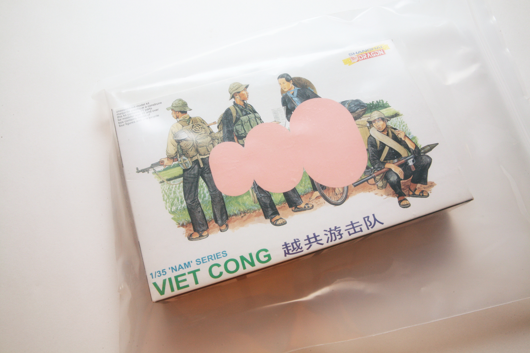 A Viet Cong model kit box painted with a pink geometric shape of three ovals.