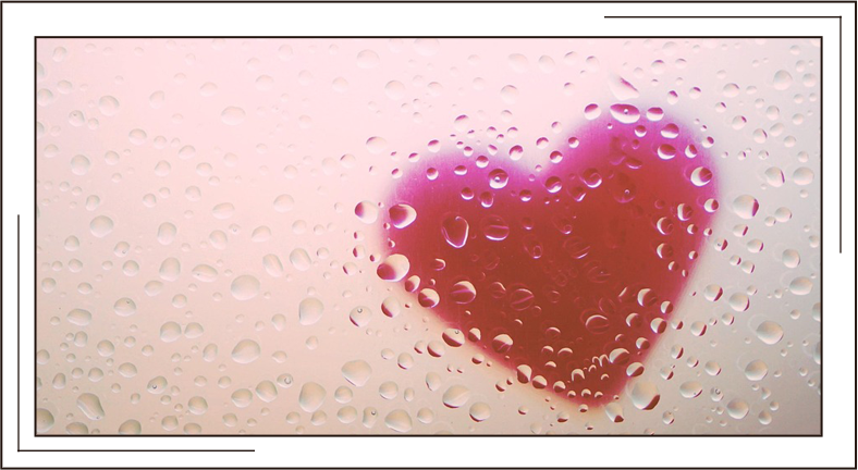 Blurred heart behind clear wet wall