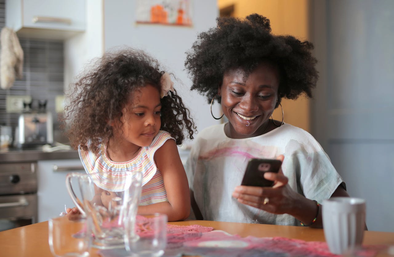 Mother and daughter Looking at Mobile 