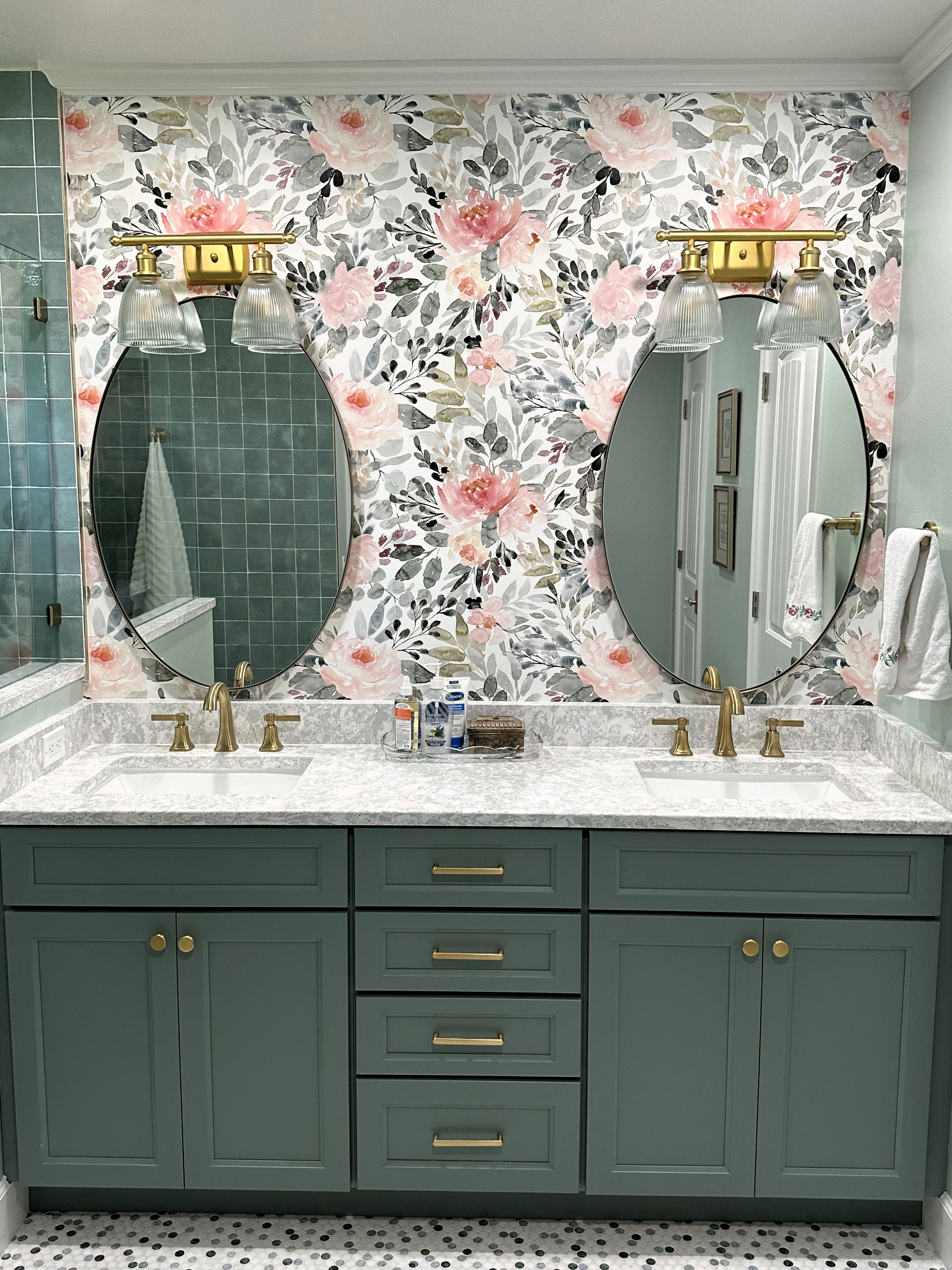 Semi-custom cabinetry painted Aloe with gold hardware and Cambria quartz countertop and matching 4" backsplash make this bathroom a true showstopper.