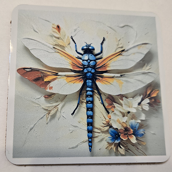 Square metal coaster with a painted dragonfly design