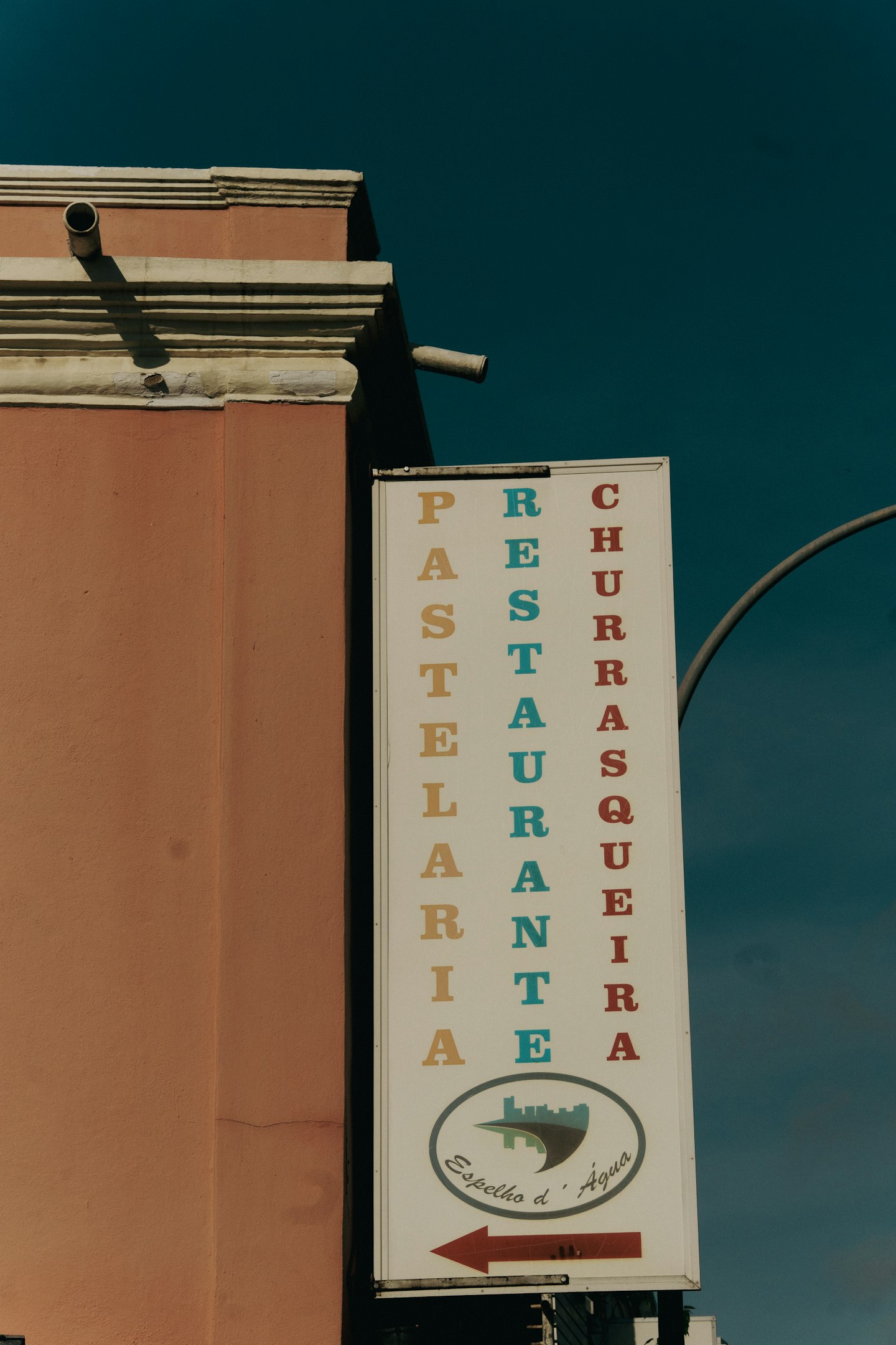 Restaurant sign in the street, with colorful words.