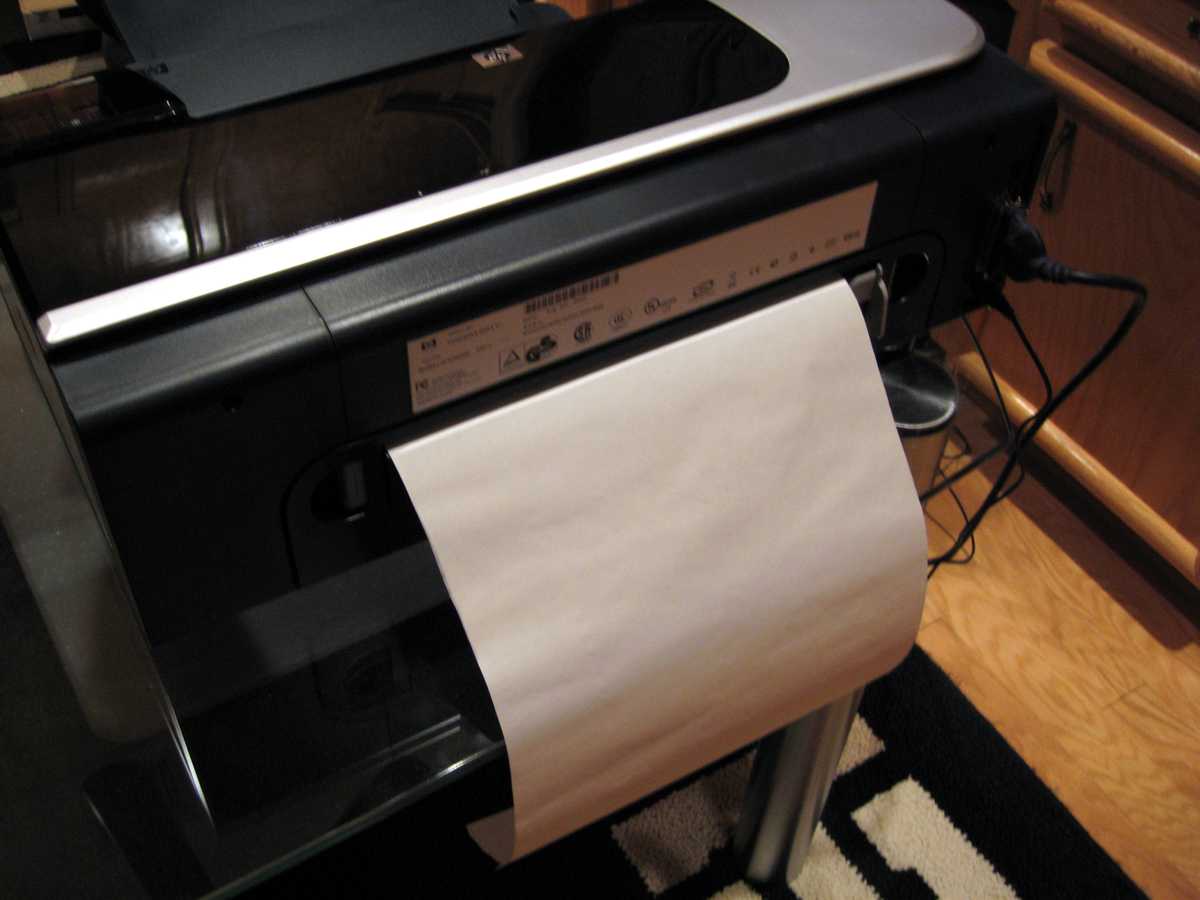 Once the tissue has been applied to the backing sheet, it is ready for printing. Place the tissue/backing sheet in the printer so the tissue will be the printed side. Shown here is an HP Model K850 printer. It supports a straight through paper path, and the tissue/backing sheet has been placed in that feed opening.
