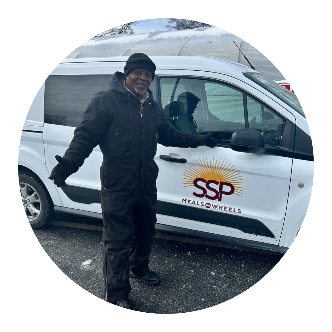 SSP employee hands Meals on Wheels client bag of meals at their doorstep.