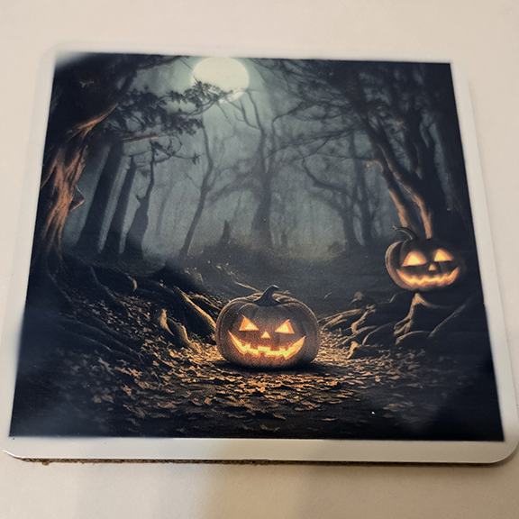 Square metal coaster with a pumpkins at night design