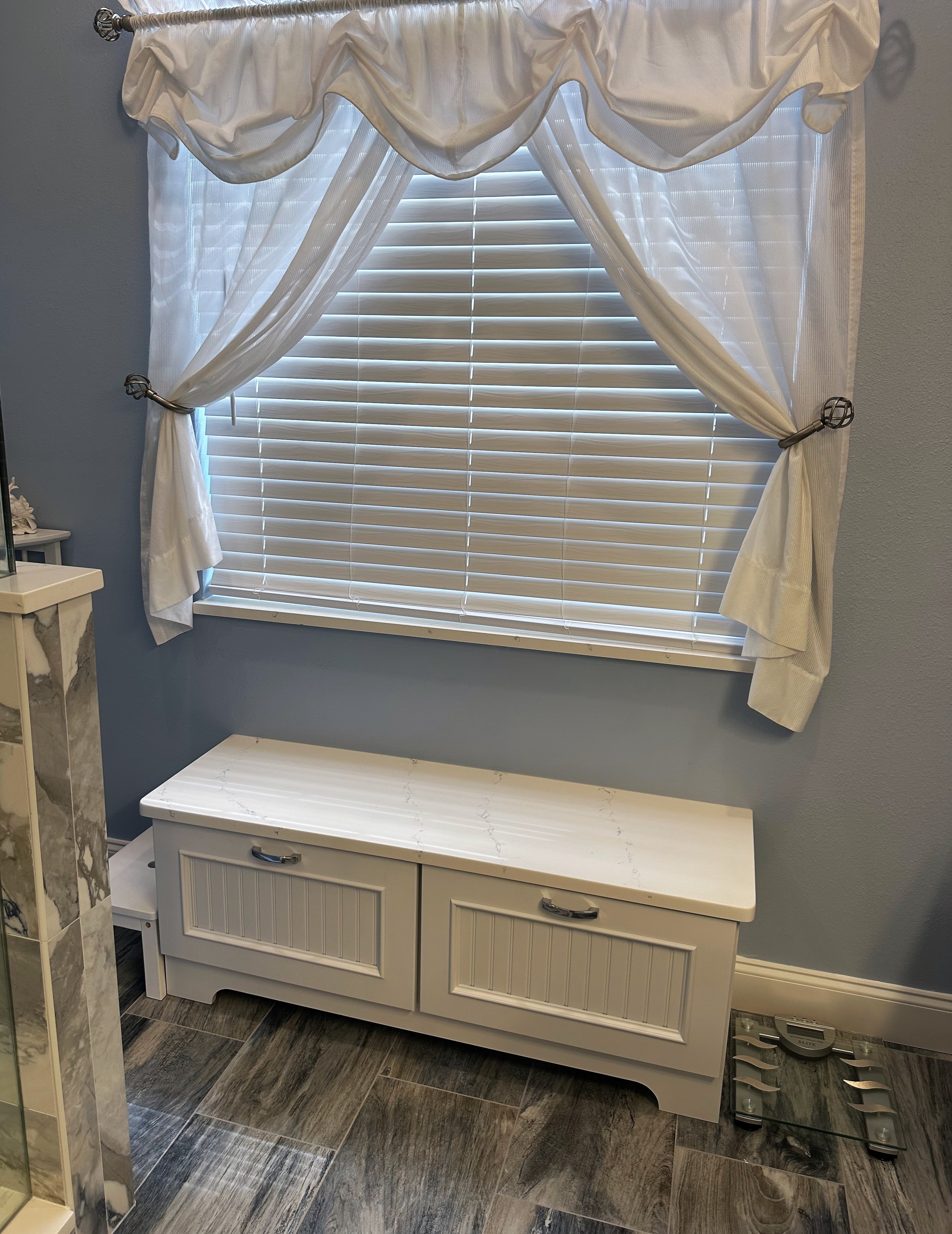 Lovely bead board bench with extra storage painted Magnolia with HanStone Tranquility quartz countertop.