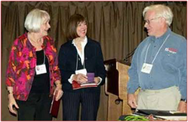 Life member Brenda Viney and Darlene Sanders worked for years to bring the World Federation of Rose Societies Convention to Vancouver in June 2009. VRS member and WFRS vice president David Elliot presents them with medals.