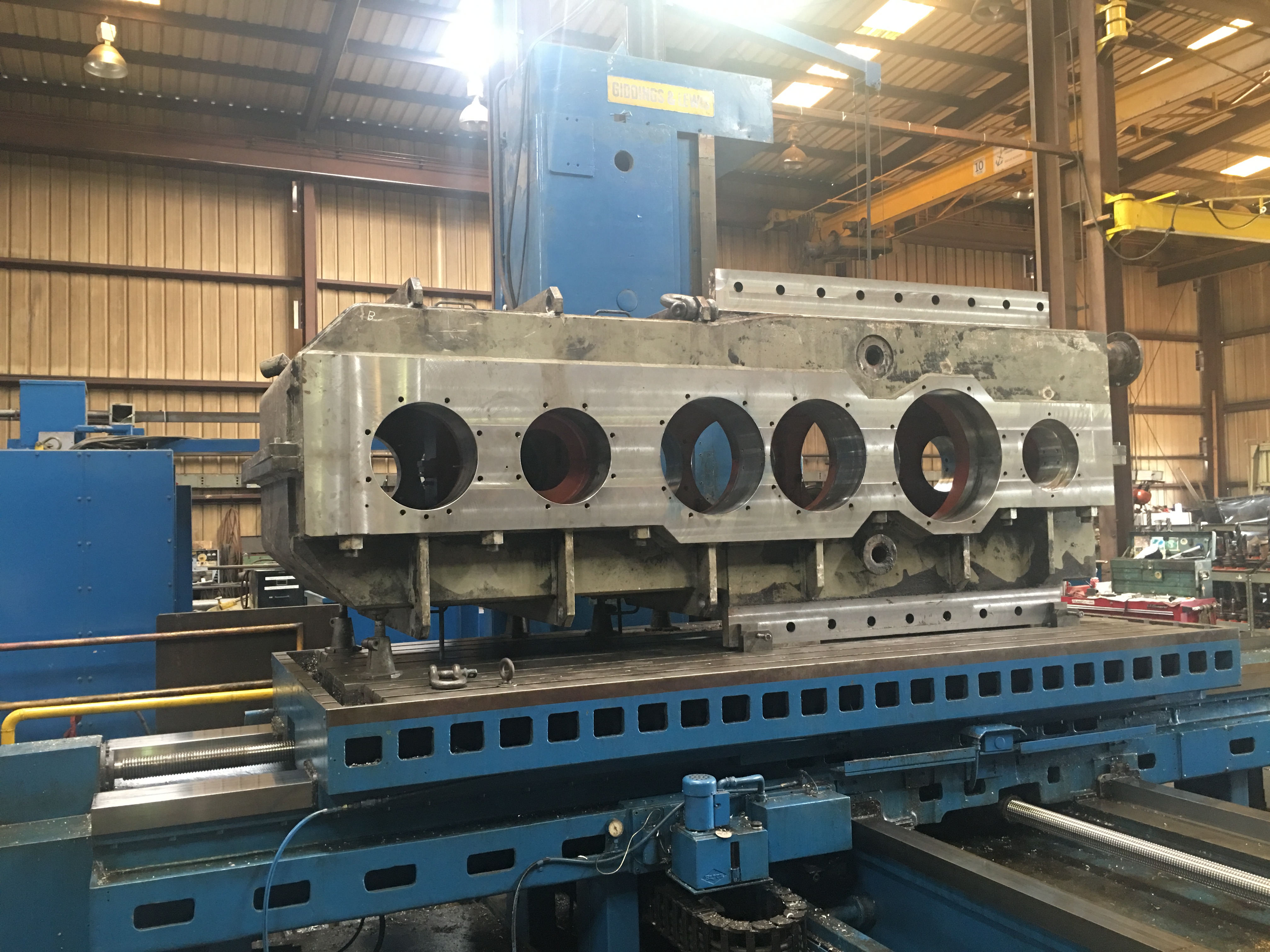 Close-up of a CNC machine in operation, with intricate metal components and glowing sparks in an industrial setting.