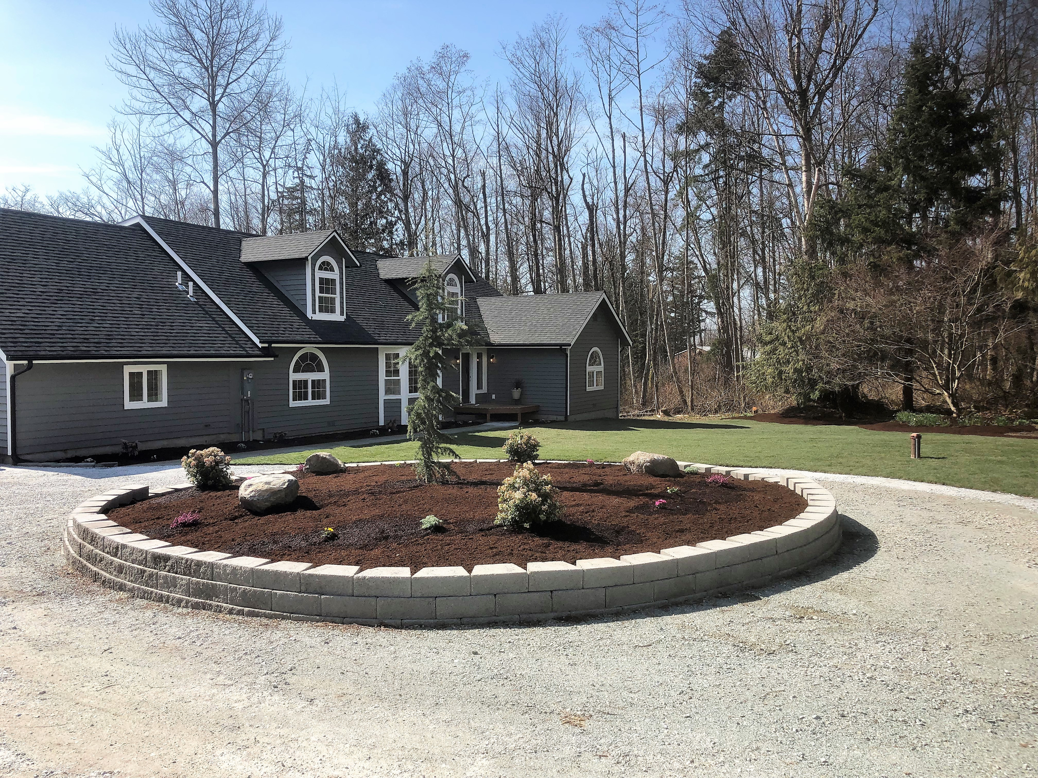 Driveway, plant-bed, and sod.