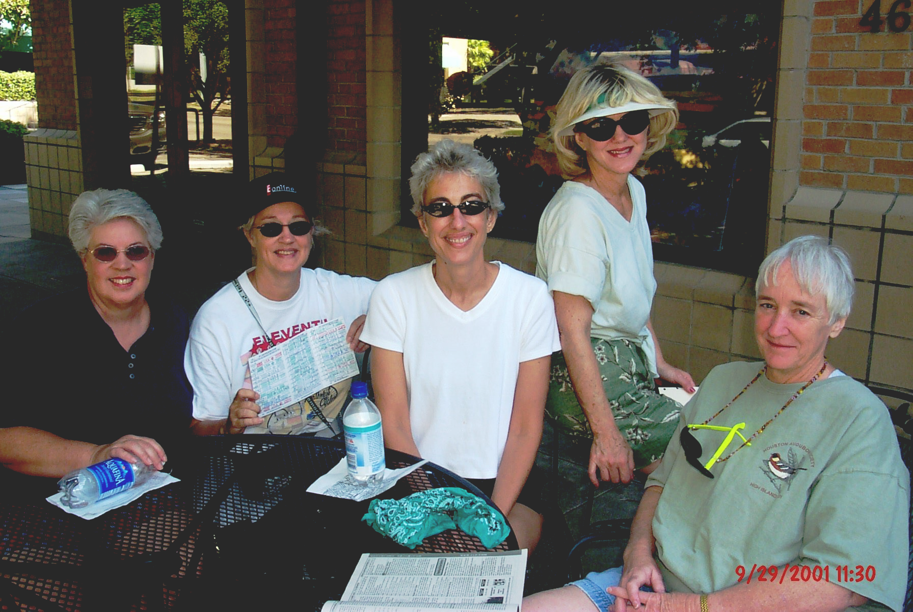 Group of runners jogging during a marathon on a sunny day, surrounded by trees and spectators. Group of runners jogging during a marathon on a sunny day, surrounded by trees and spectators.