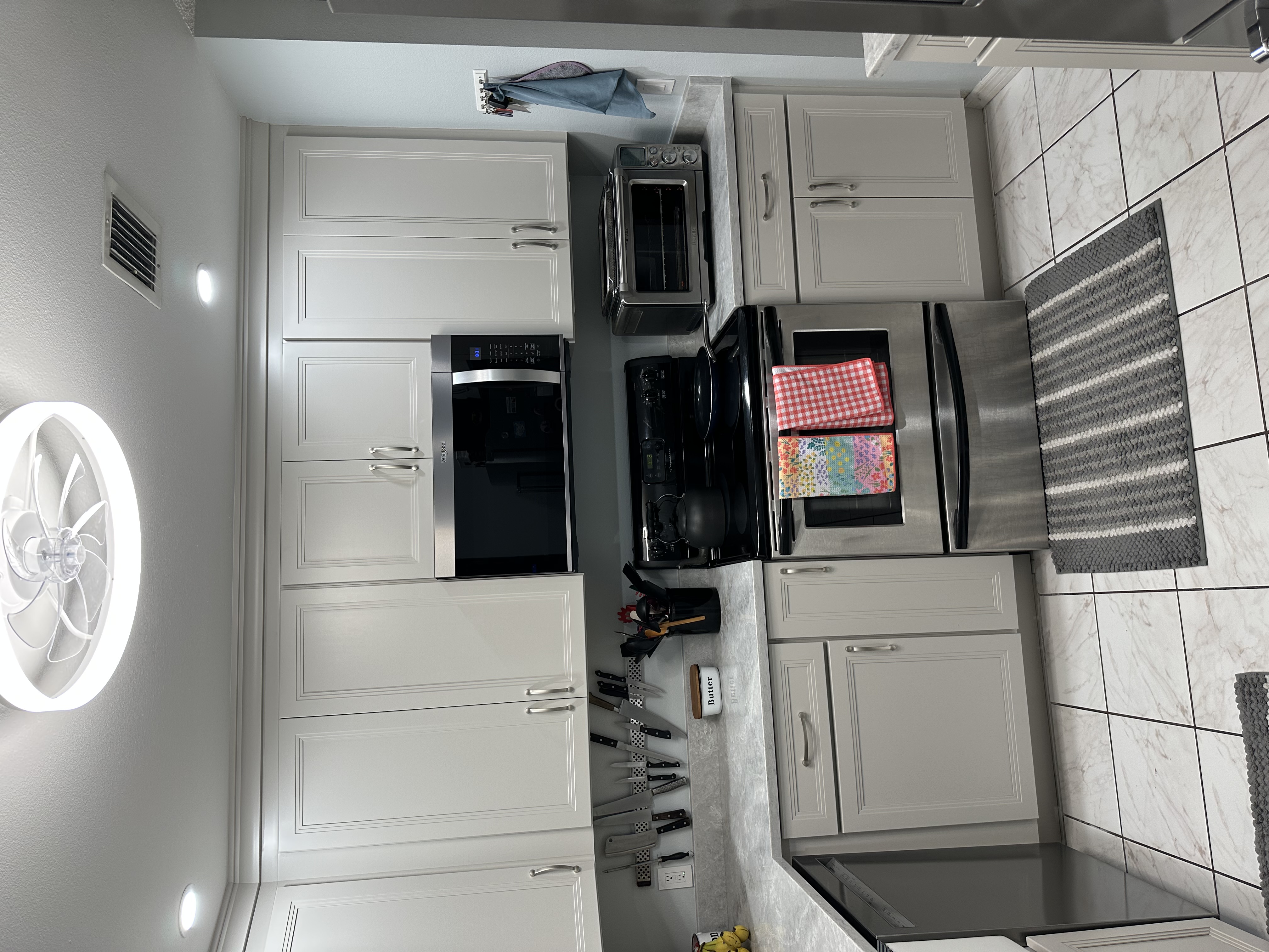 This lovely kitchen offers plenty of countertop space and storage, perfect for meal prep and cooking.