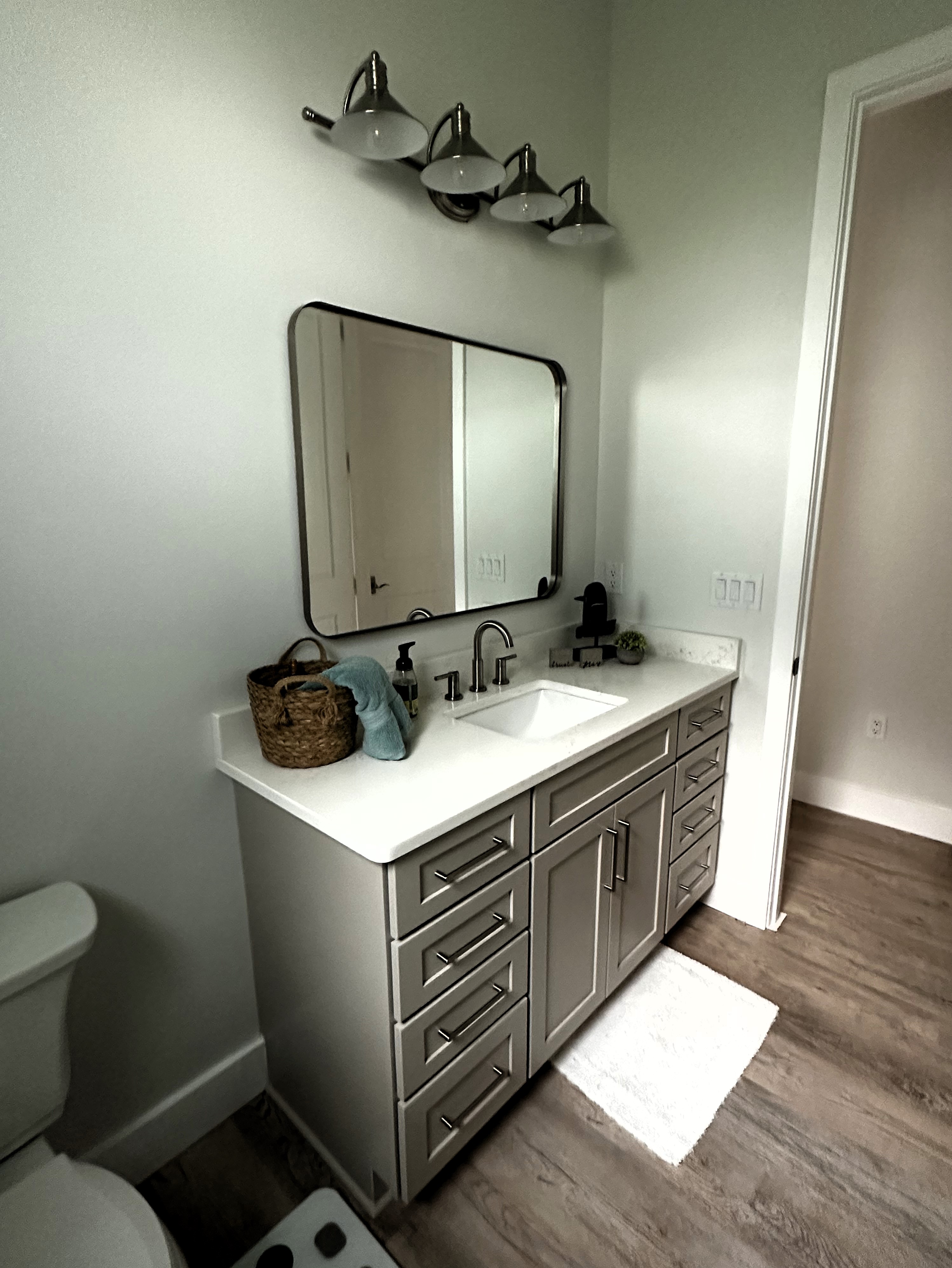 Spacious vanity with dual drawers for storage featuring a perfectly framed mirror above sink.