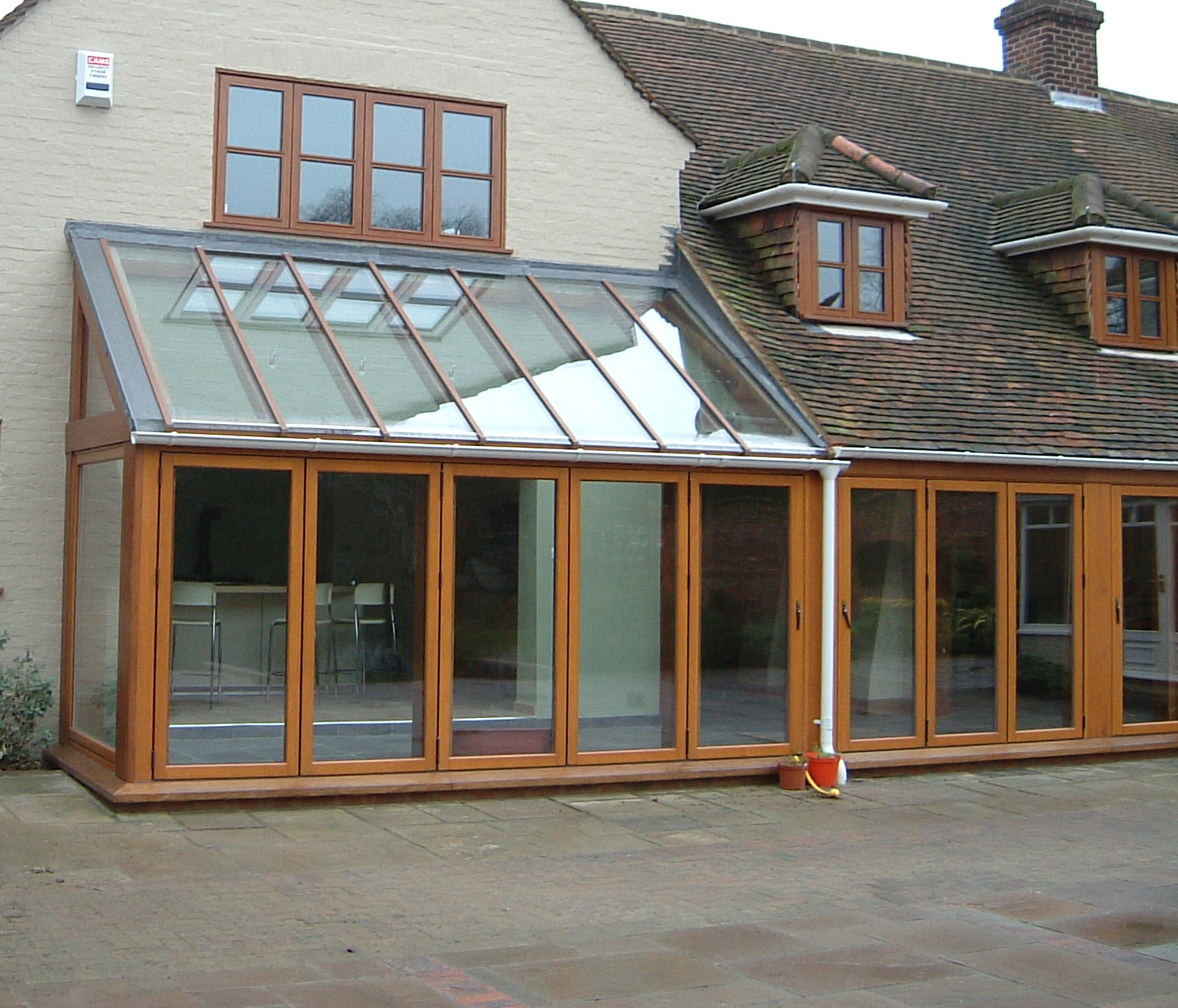 a room with a table chairs and a lamp