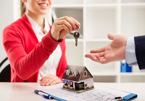 Woman Realtor Giving Key Woman Realtor Giving Key