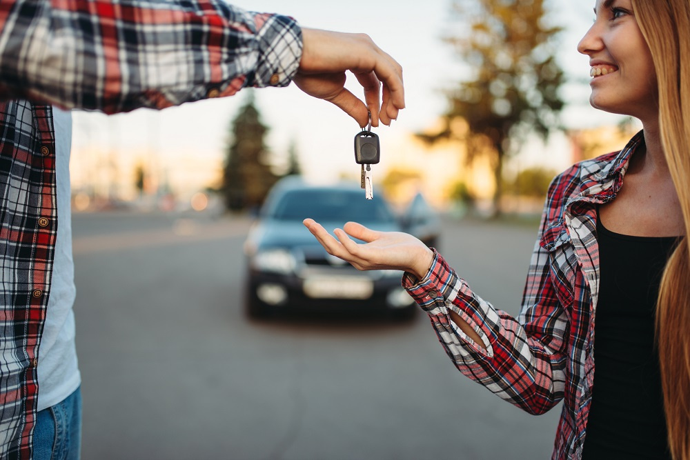 Dad handing keys over to daughter