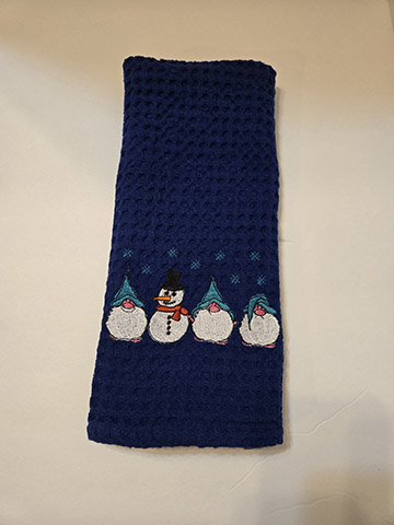 Dark blue waffle hand towel featuring a snowman with gnomes design