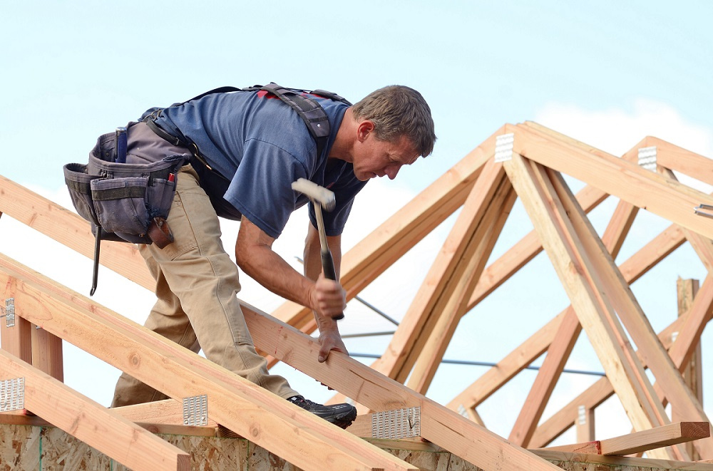 Person Installing Roof Truss Straps to a Roof